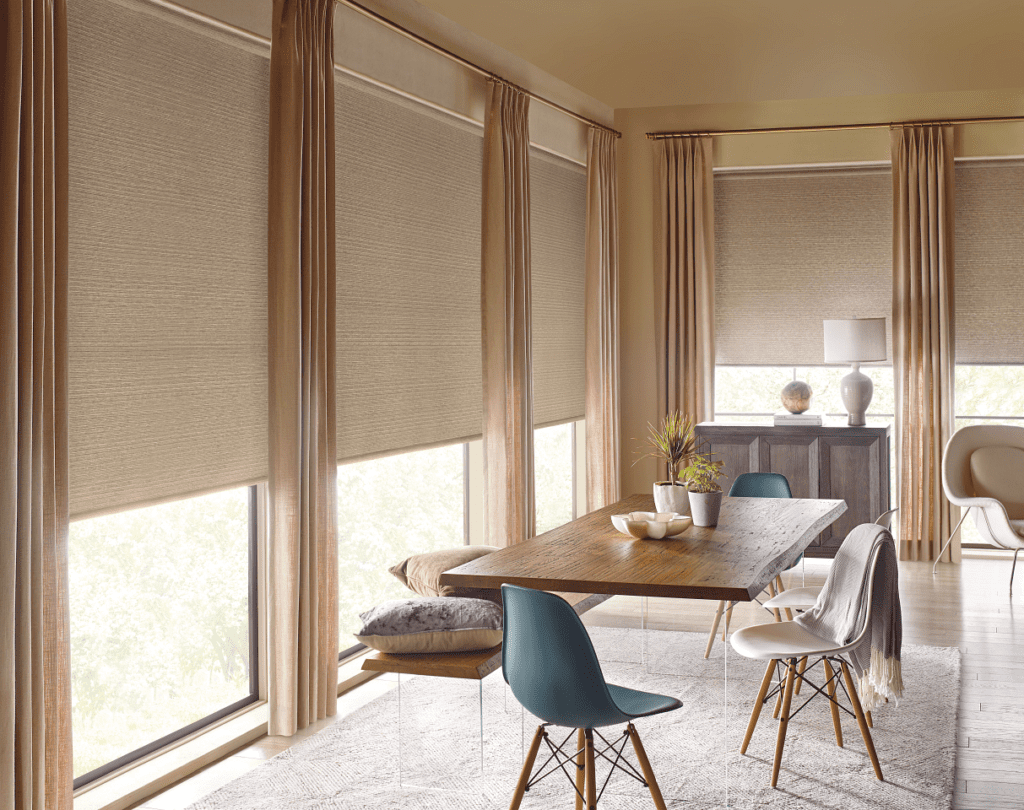 Tan roller shades and matching drapery in dining room